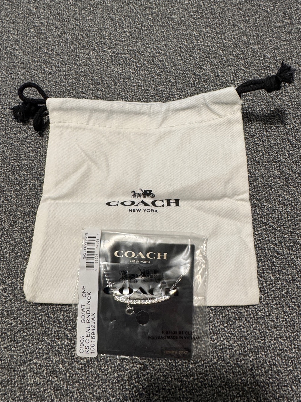 Coach Silver-Tone necklace with White Drawstring Pouch